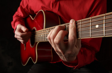 Guitarist playing an acoustic guitar