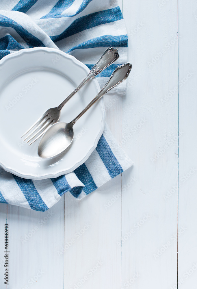 Wall mural cutlery, porcelain plate and white linen napkin