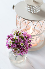 pink flowers and candle lantern