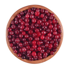 Fresh red cranberries in a wooden bowl on a white