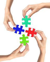 Red and blue puzzle in woman hands isolated on white