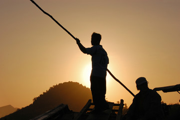 Silhouette of fishermen at sunrise