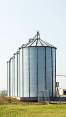 silver silos in field