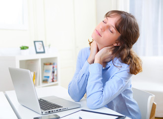 Portrait of young smiling business woman relaxing at work