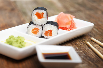 Three salmon sushi on a little plate