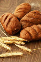 Four loaves of bread and wheat ears
