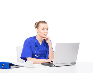 A cheerful female doctor working in office isolated on white