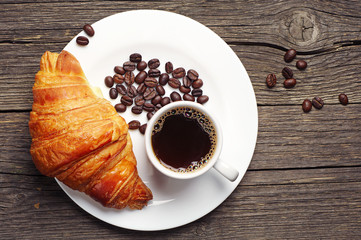 Coffee cup with a croissant