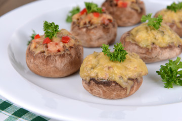 Stuffed mushrooms on plate on table close-up