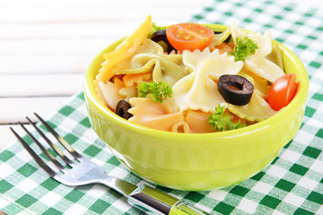 Delicious pasta with tomatoes on plate on table close-up