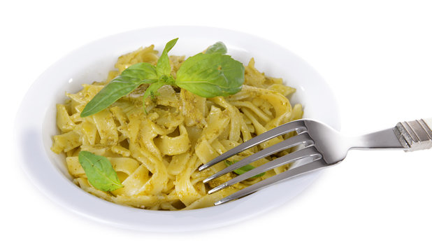 Delicious pasta with pesto on plate isolated on white