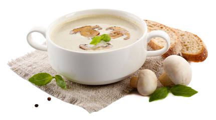 Mushroom soup in white bowl, on napkin, isolated on white
