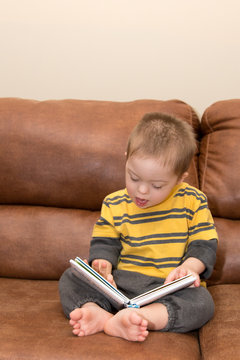 Down Syndrome child reading a book