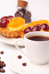 A cup of espresso and fruit tartlets