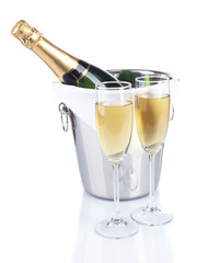Glasses of champagne in pail, isolated on white