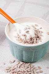 A bowl with cream and sunflower seeds