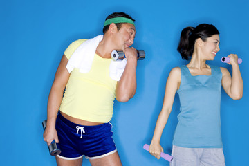 man and woman with dumbbell