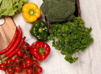 Different color vegetables on a wooden surface