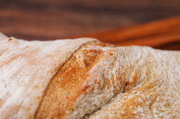 A closeup picture of bread crust topped with flour