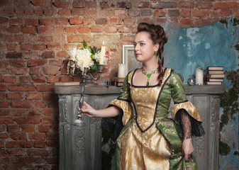 Beautiful woman in medieval dress with candelabrum