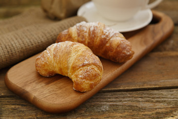 Two sweet croissants on a cutting board