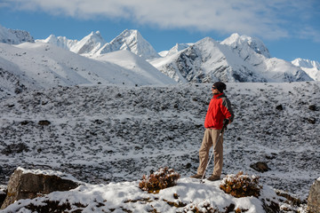 Hiker posing in Himalayas in front of big mountains