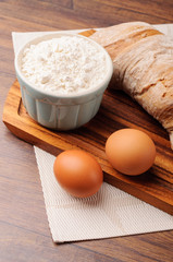 Two eggs with flour and bread