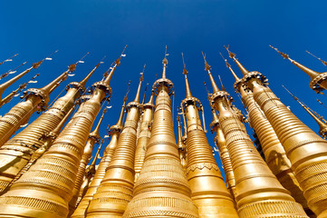 Golden stupas of Shwe Indein Pagoda over blue sky. Myanmar