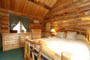 Cozy bedroom in log cabin house