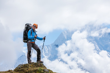 Hiker posing in Himalayas in front of big mountains