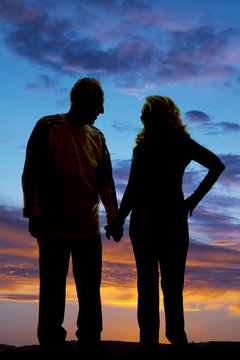 silhouette elderly couple holding hands walk