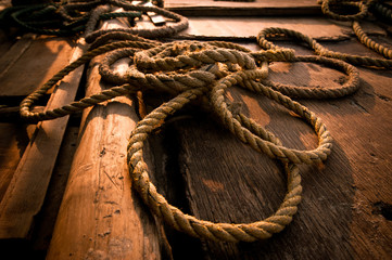 Coarse coconut rope at wooden fishing boat deck