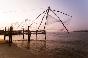 Sunset at tropical beach with chinese fishing nets