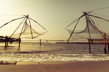 Sunset at tropical beach with chinese fishing nets