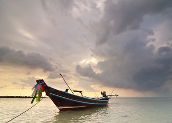 Fototapeta na wymiar Sunset at tropical beach with Thai fishing boat. Thailand