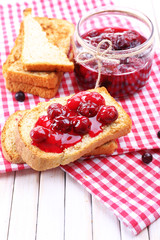 Delicious toast with jam on table close-up