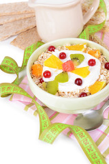 Delicious oatmeal with fruit in bowl on table close-up