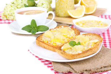 Delicious toasts with lemon jam on plate on table close-up