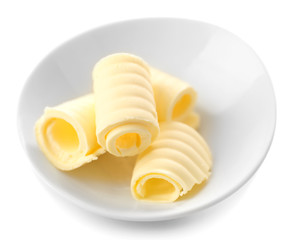 Curls of fresh butter in bowl, isolated on white