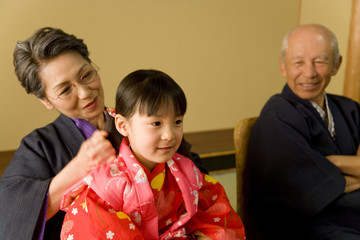 grandchild having shoulder massage done by grandmother