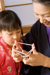 grandmother and girl who do cat's cradle