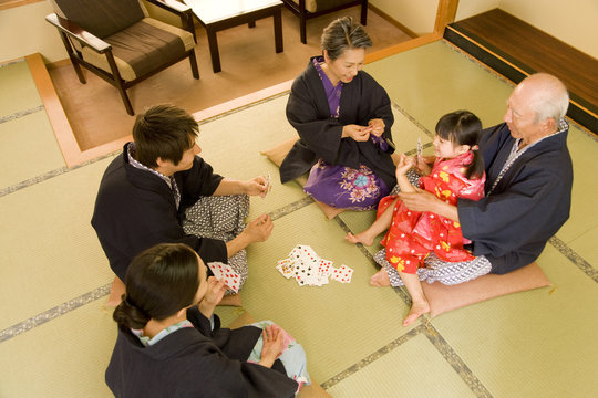 three-generation family playing cards