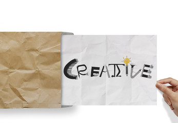 d pulling crumpled paper from envelope with design word  CREATIV