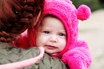 young mother with her two month baby outdoor