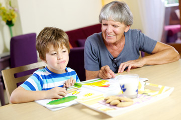 Obraz premium Happy child ready to relax with biscuits during homework