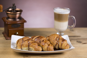 Coffee with whipped cream and croissant, donuts