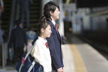 high scool student waiting for train on the platform