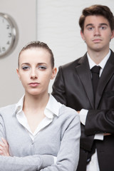 Two business people posing with arms crossed