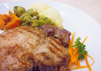 Grilled pork steaks baked potatoes and vegetable salad