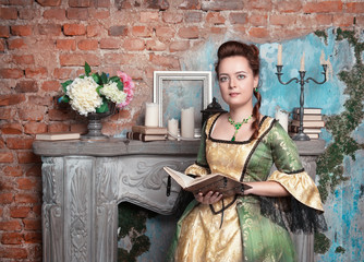 Beautiful woman in medieval dress with book